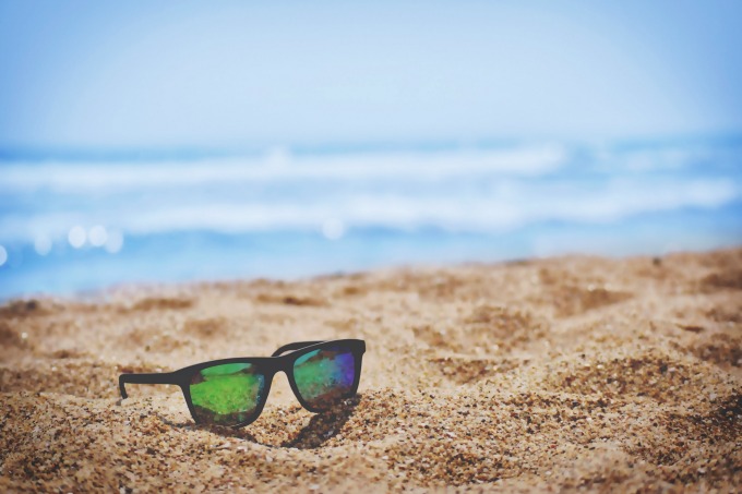 sunglases in the sand at the beach