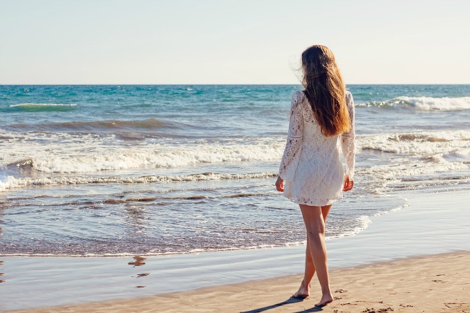 Woman at the beach covered up