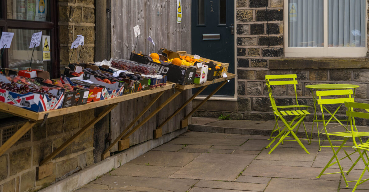 Photo of a farm shop selling local produce including fruit and vegetables Also in the image is an outdoor market and seating area for customers If you use this image please credit