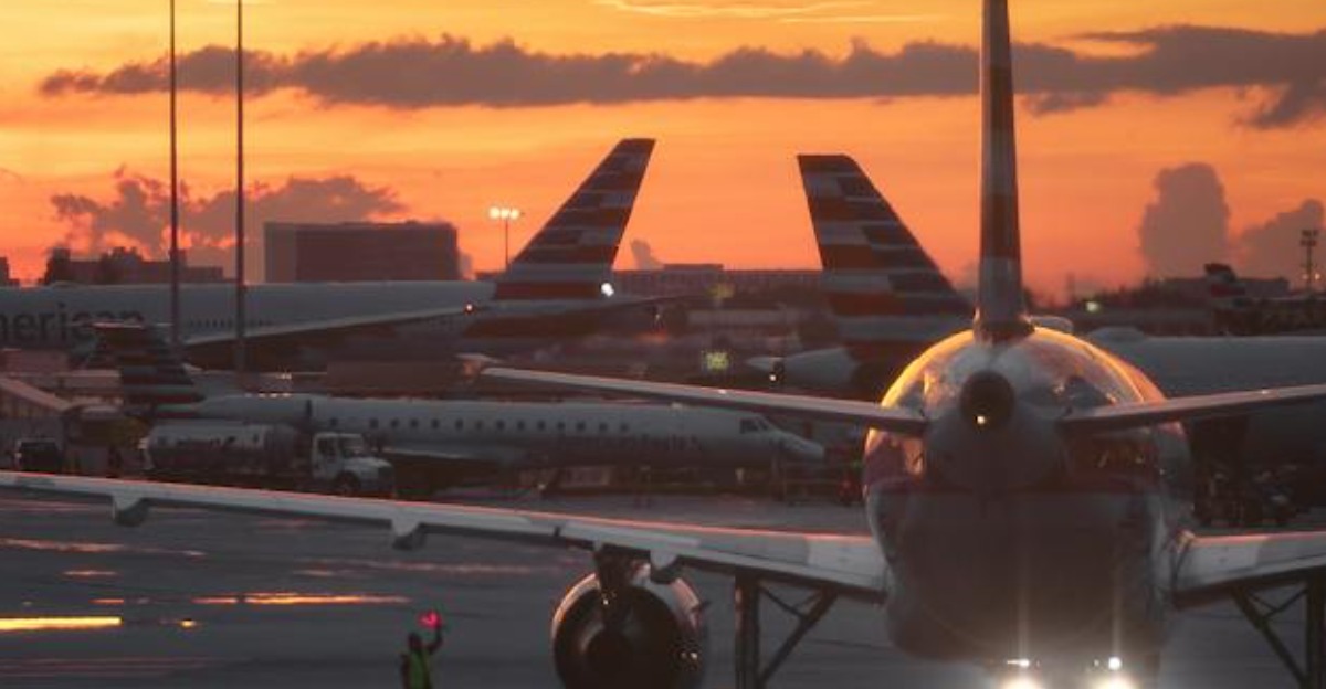 Airplane on the tarmac during a vibrant Miami sunset, showcasing aviation atmospheres.