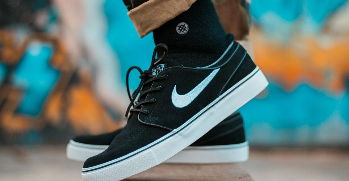 Close-up of black sneakers with camouflage pants showcasing urban style