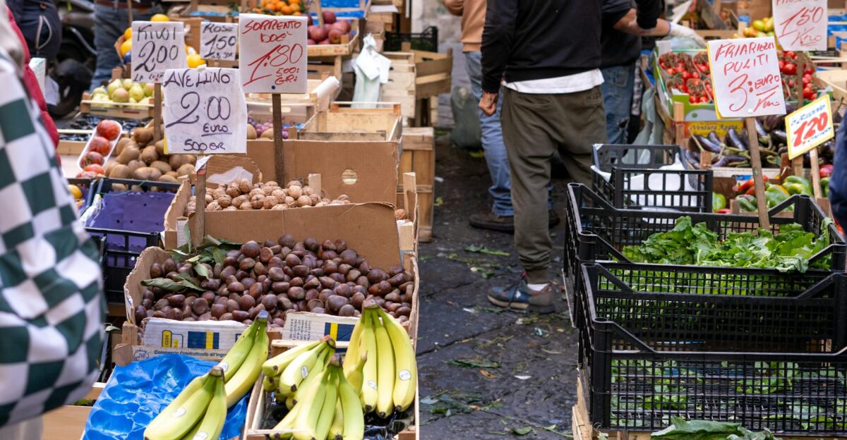 Colorful display of fruits and vegetables at a bustling outdoor market