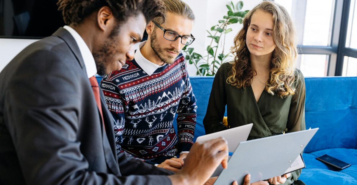 A diverse group of young professionals engaged in a business meeting inside a modern office