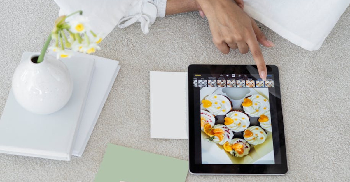 Young woman using a tablet in a modern, minimalist workspace with pastel decor.