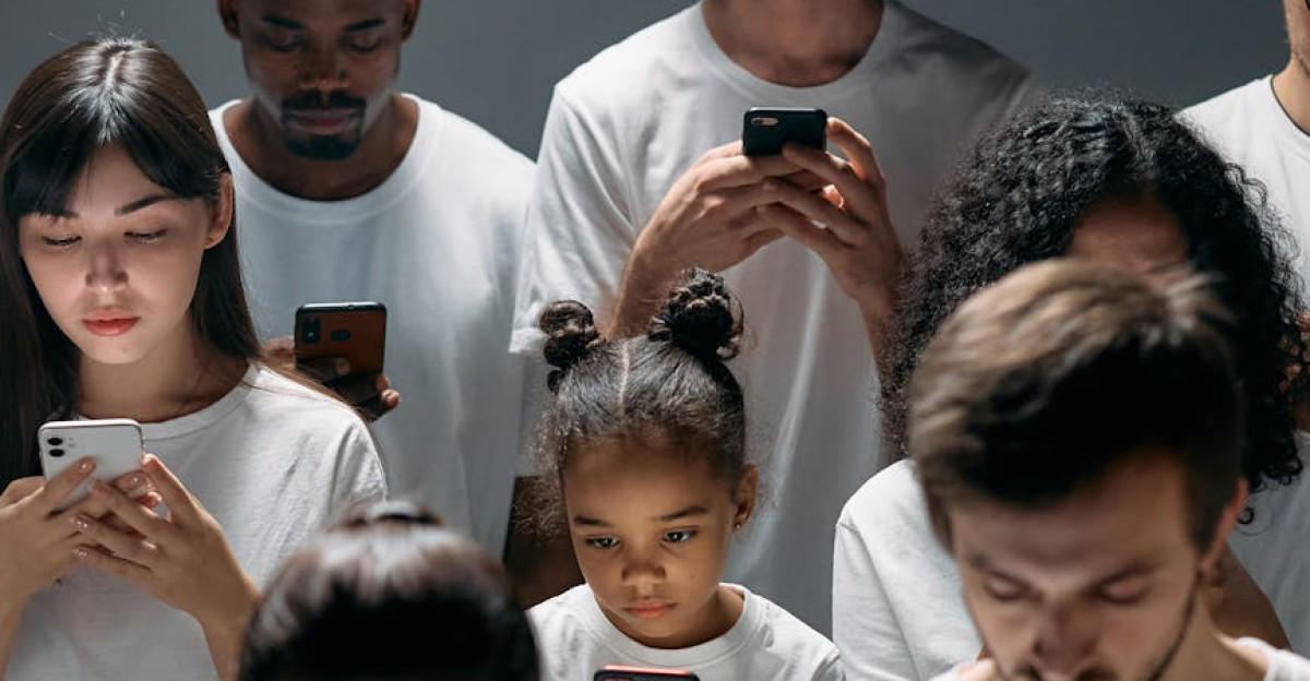 A diverse group of people focused on their smartphones symbolizing modern technology s impact on social connection