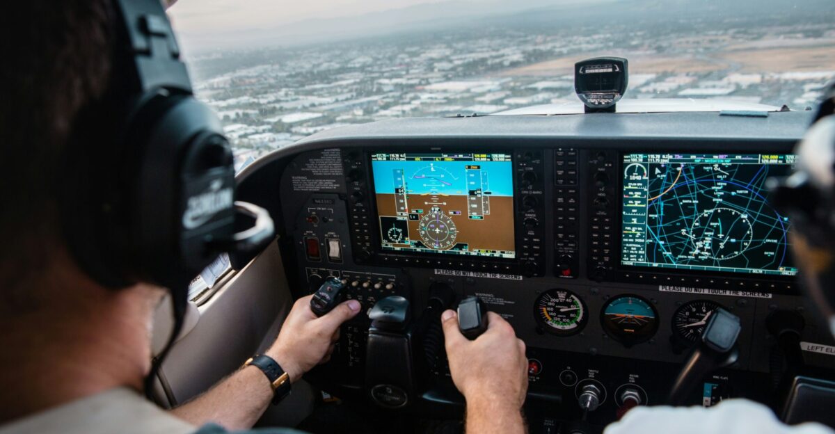 man flying aircraft under cloudy sky