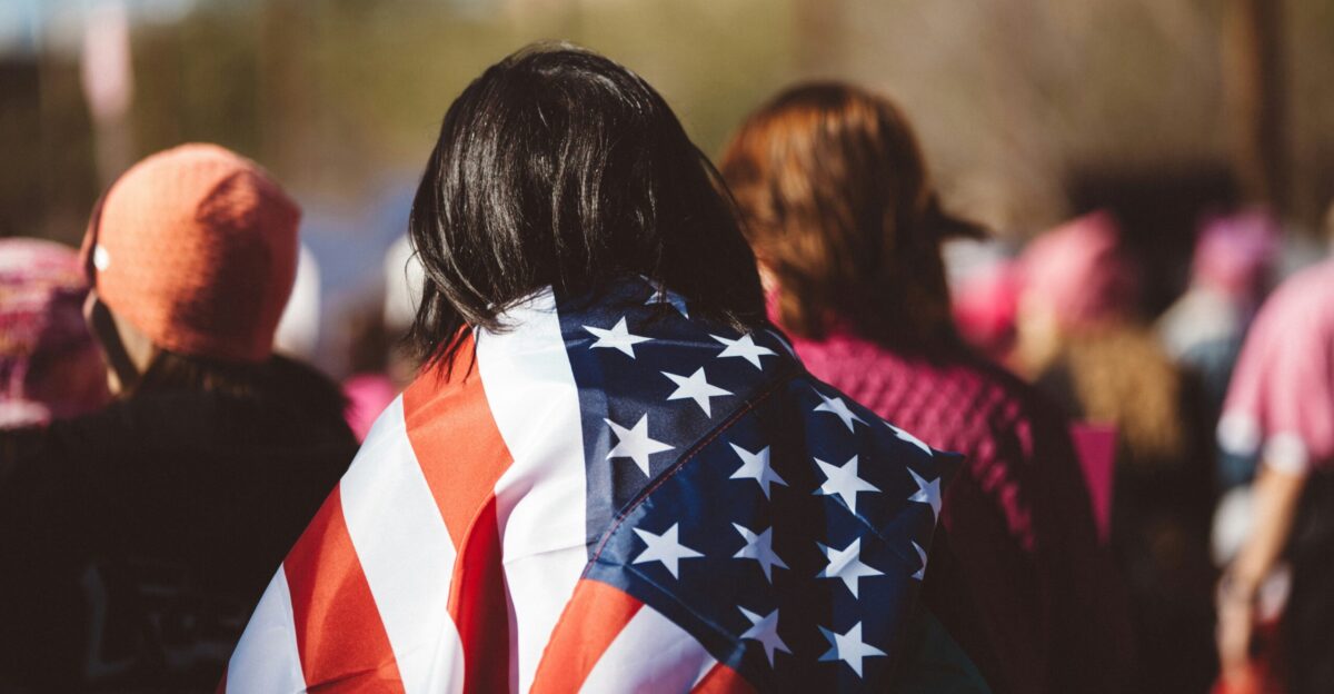 woman with US American flag on her shoulders