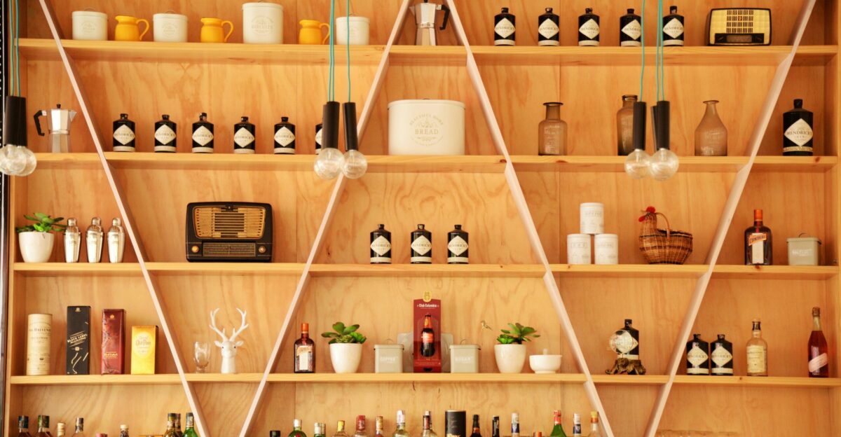clear glass bottles on brown wooden shelf