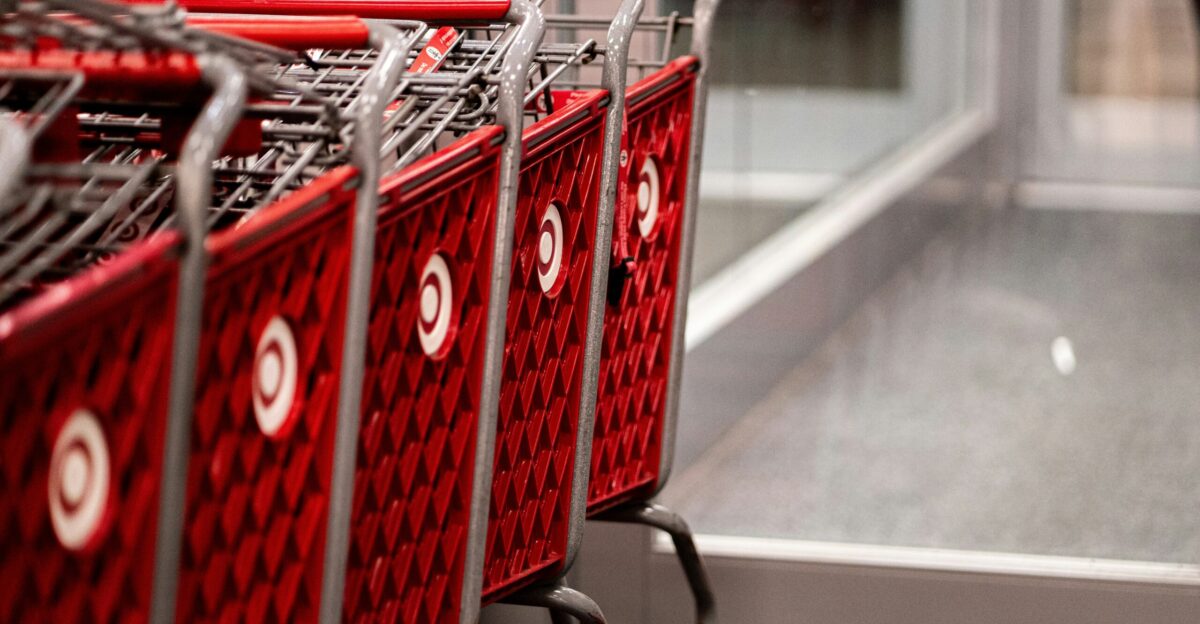a row of red shopping carts sitting in front of a store