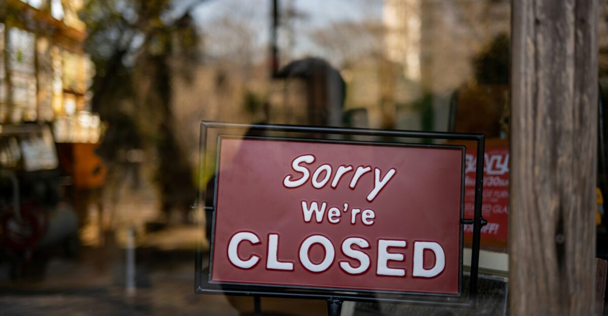 a closed sign in a store window that says sorry we're closed