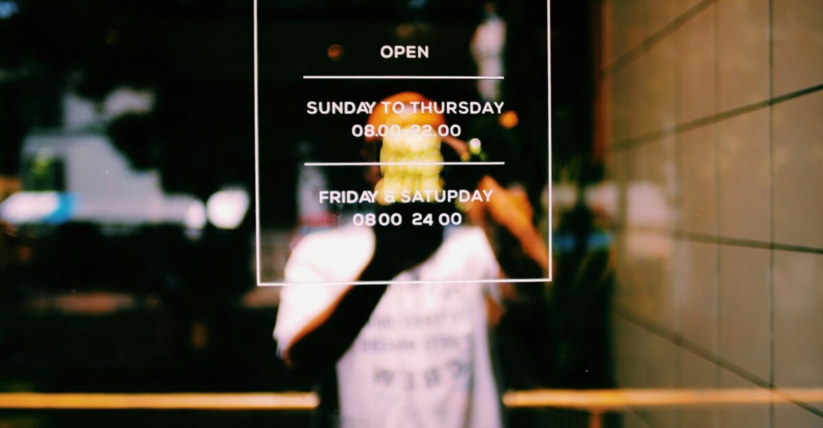 a person standing in front of a sign