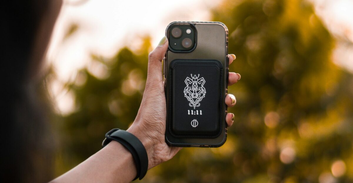a woman holding up a cell phone in her hand