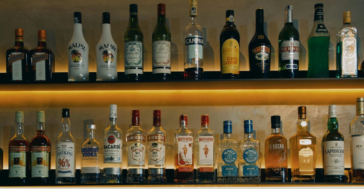 a shelf filled with lots of different types of liquor