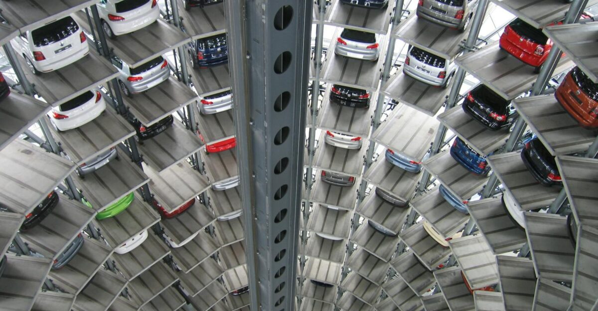 A vertical view of a spiral multi-storey car park filled with vehicles