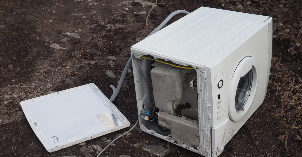 A broken Samsung washing machine that someone just left as trash on a public footpath in Tapiola Espoo Finland