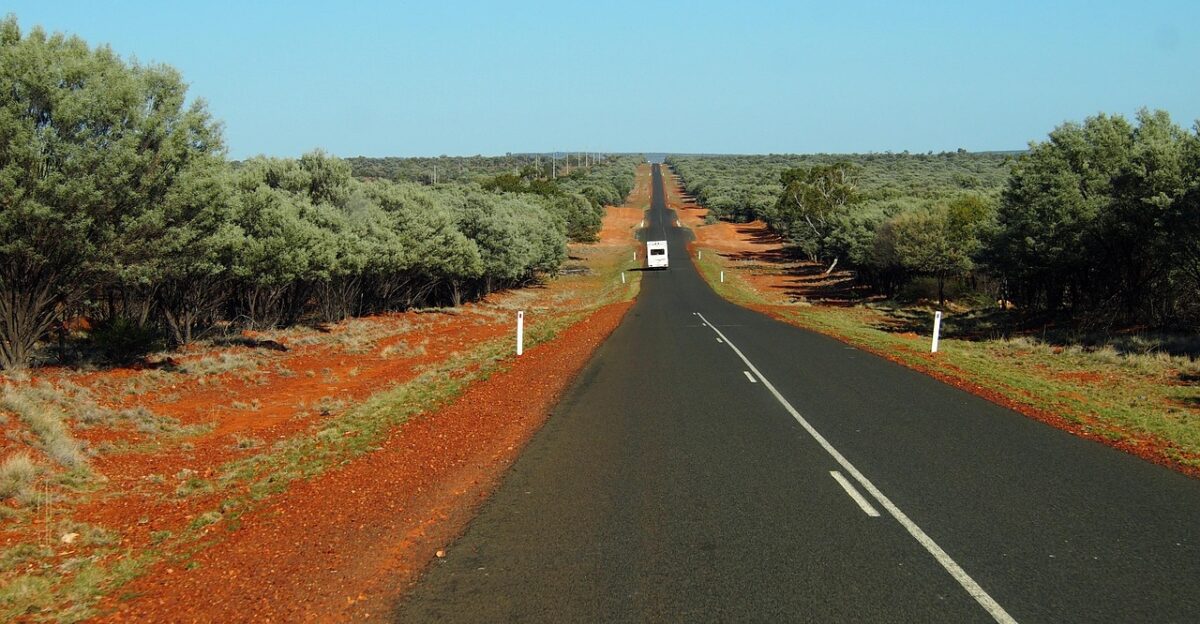 road outback nature desert red dirt road ahead deserted desolate