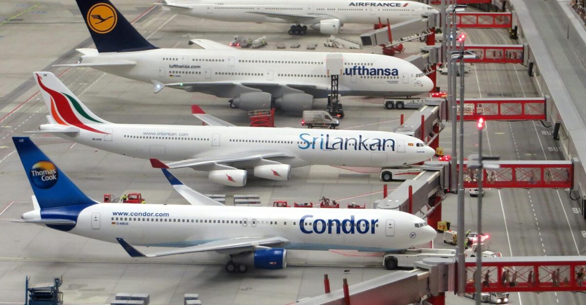 Detailed miniature model of an airport terminal with various aircraft brands on display
