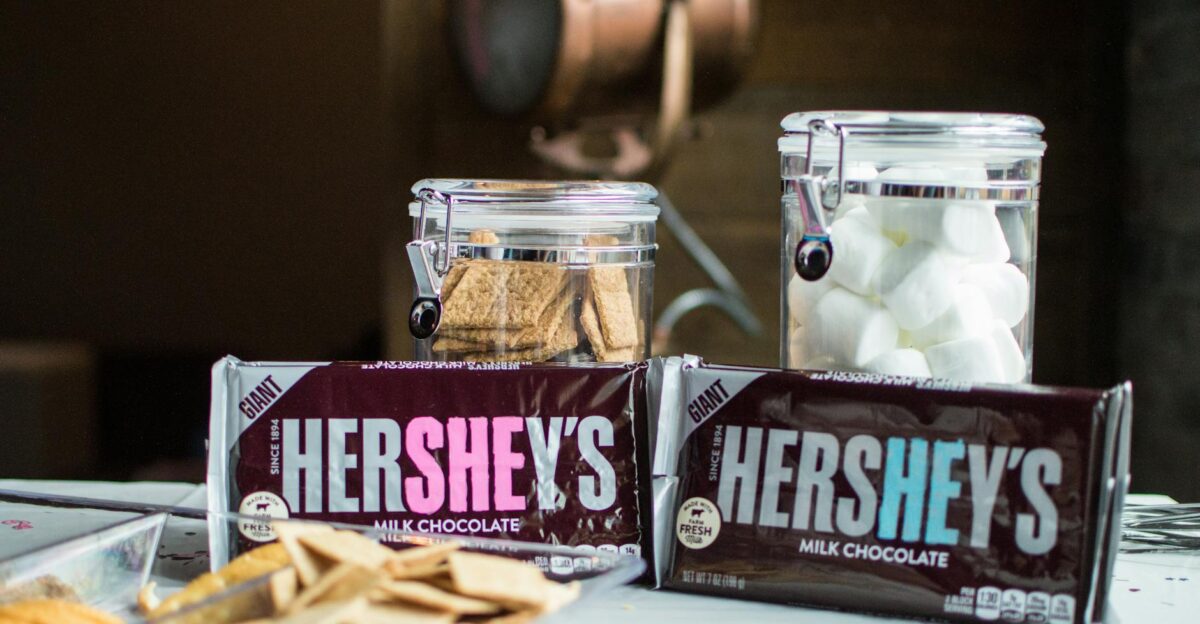 Close-up of Hershey s chocolate bars with jars of graham crackers and marshmallows for delicious s mores