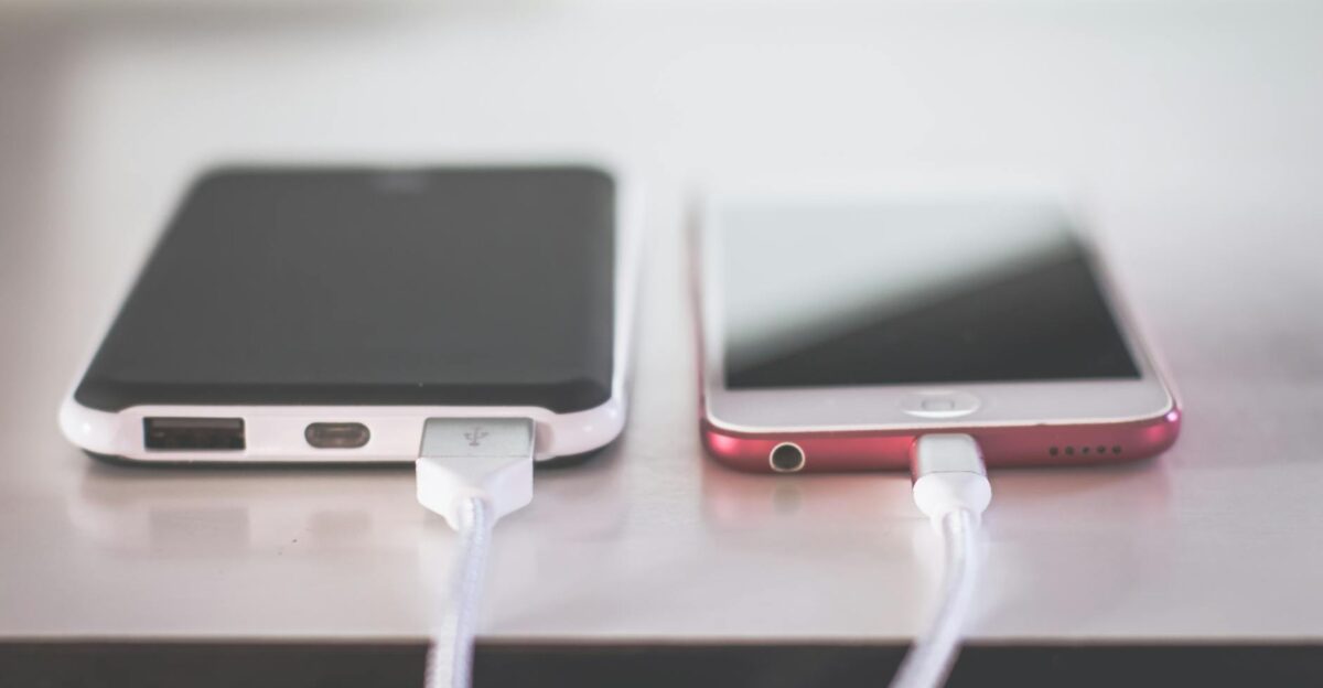Two smartphones charging side by side on a desk Modern and technological setting