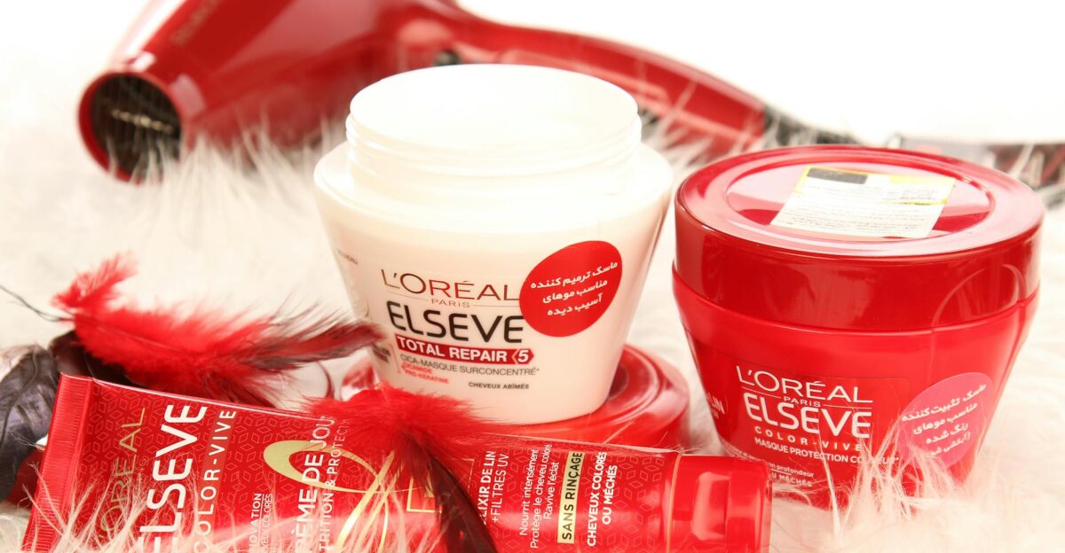 High-quality shot of L Oreal hair products and hair dryer on white fur background