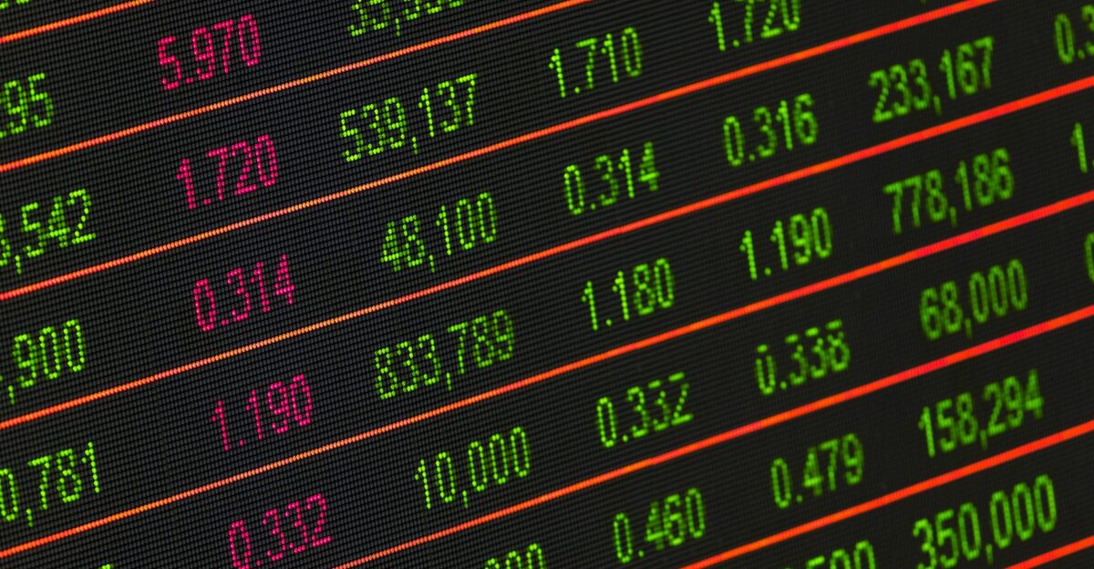 Close-up of a digital stock market data display showing colorful financial numbers and trends