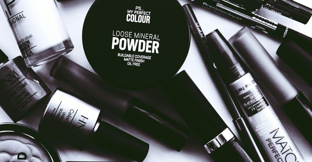 Elegant monochrome flatlay showcasing a collection of beauty products and cosmetics