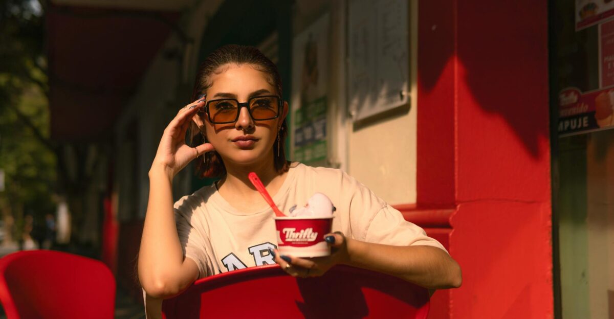A fashionable woman enjoying ice cream in the sunny streets of Ciudad de M xico
