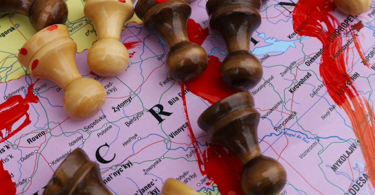 Chess pieces on a world map highlight the strategic aspect of global conflicts