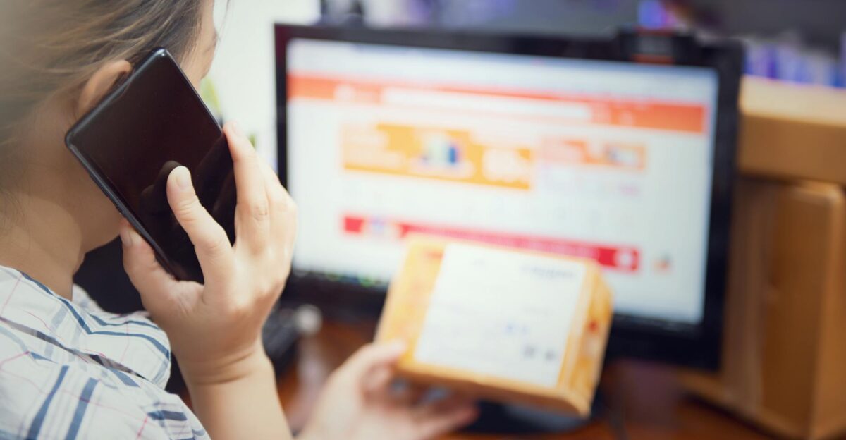 woman use mobilephone after recive box from online shopping selective focus