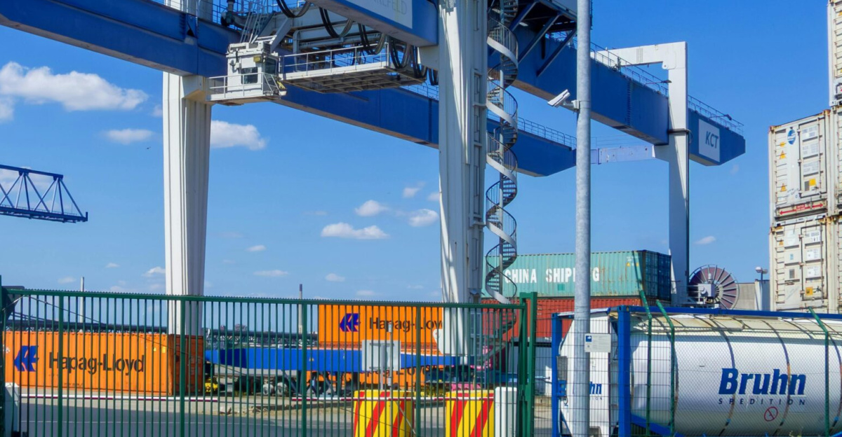Large cargo crane at Rheinhafen port in Krefeld, Germany under a clear blue sky.