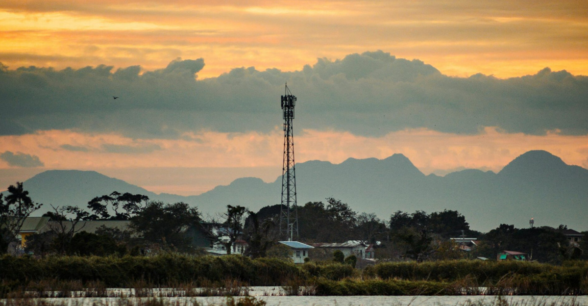 Beautiful Sunset over the leak with telecommunication tower