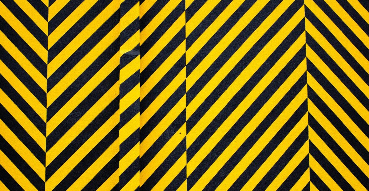 Dynamic yellow and black patterned background with bold diagonal stripes for creative design use