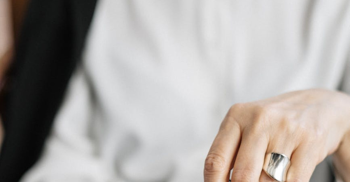 Close-up of a woman holding glasses symbolizing thought and professionalism