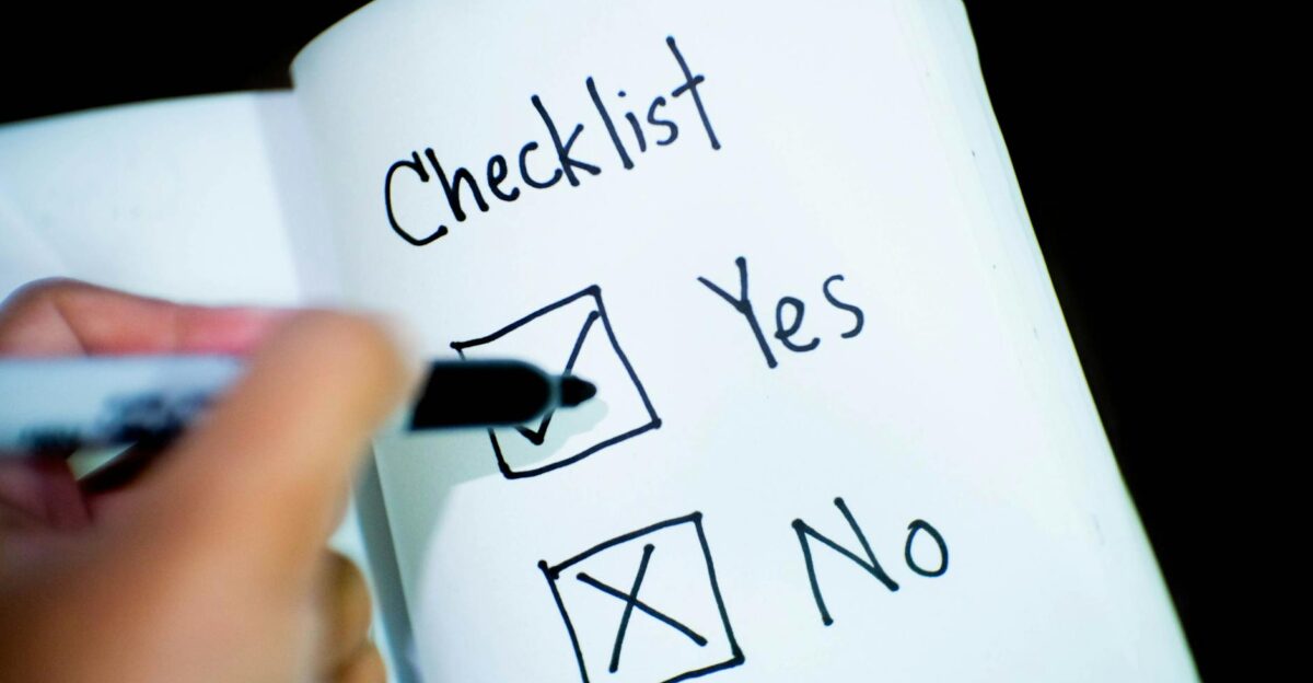 A notebook featuring a checklist with a marked Yes box captured in a close-up shot