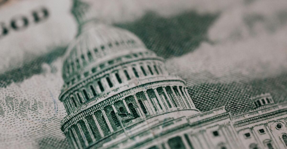Close-up of the US Capitol illustration on American currency showing detailed architectural design