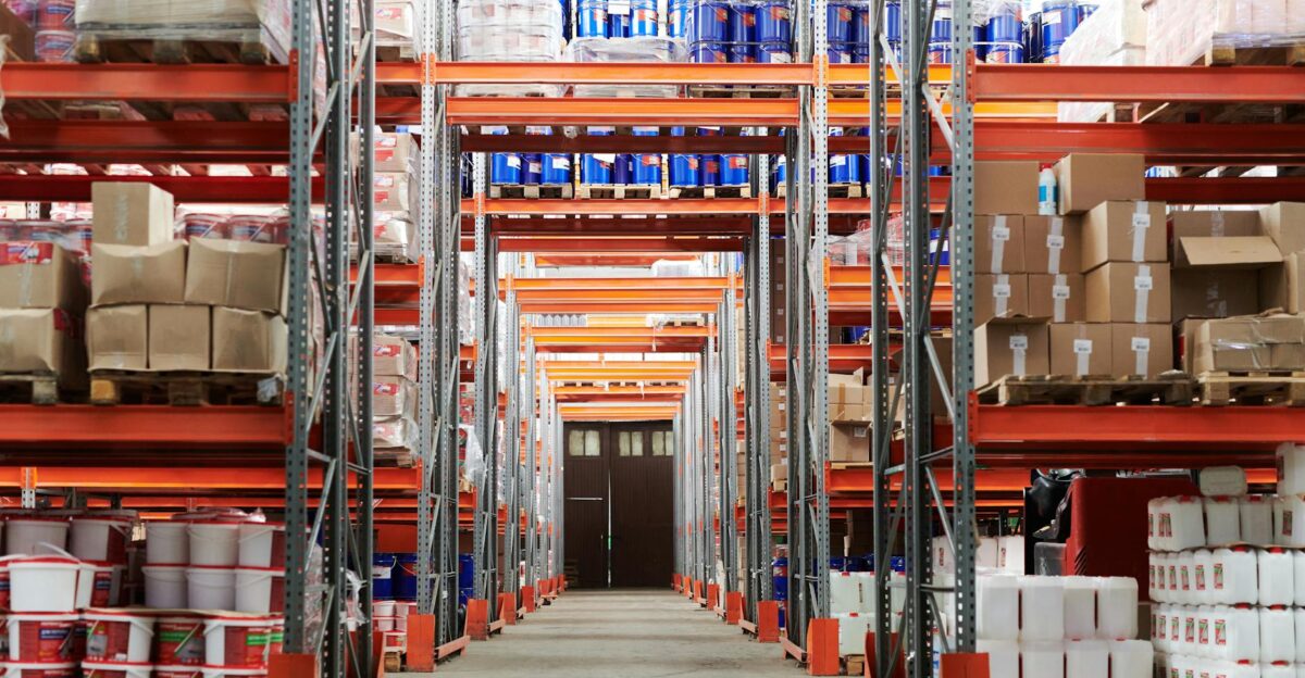 Wide angle view of a warehouse with stocked shelves and boxes