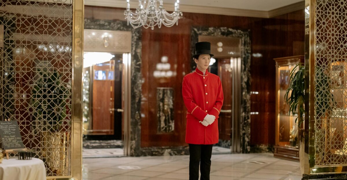 Elegant hotel lobby showcasing a uniformed doorman ready to welcome guests