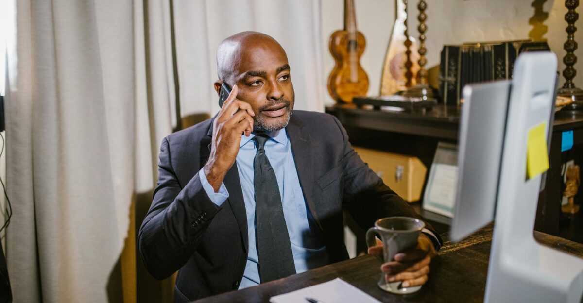 Business professional in a home office setting on phone working remotely