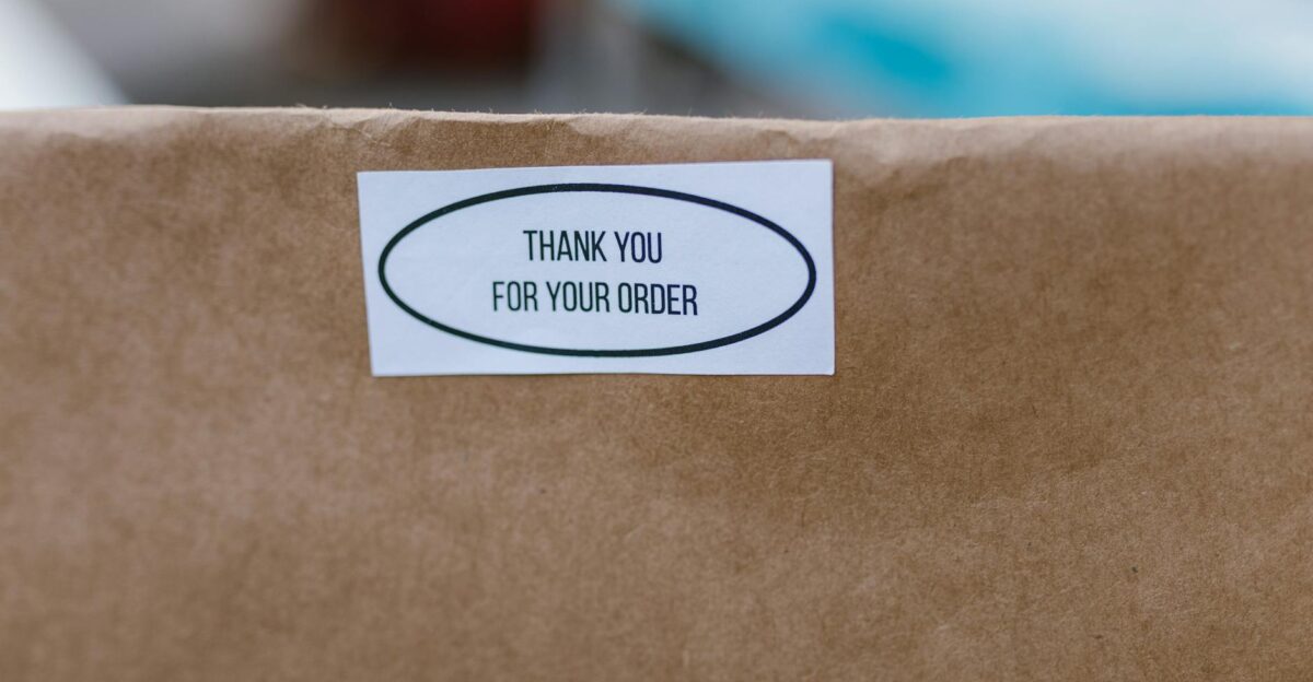 Brown paper bag with a thank you sticker ideal for delivery concepts