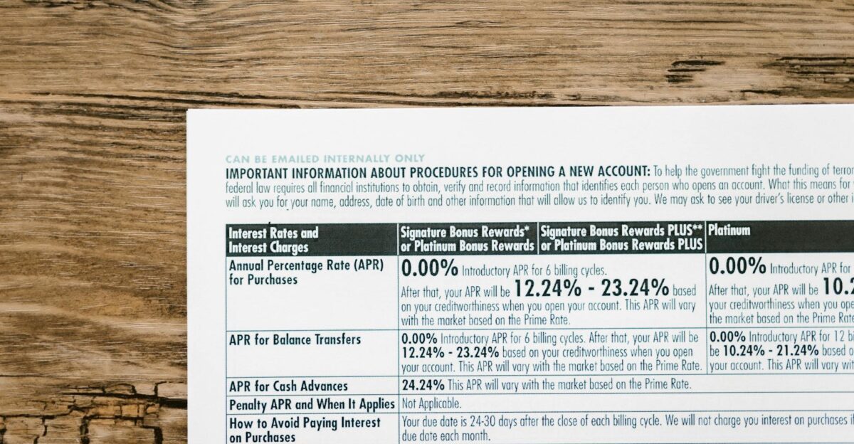 A detailed financial document listing interest rates on a textured wooden table