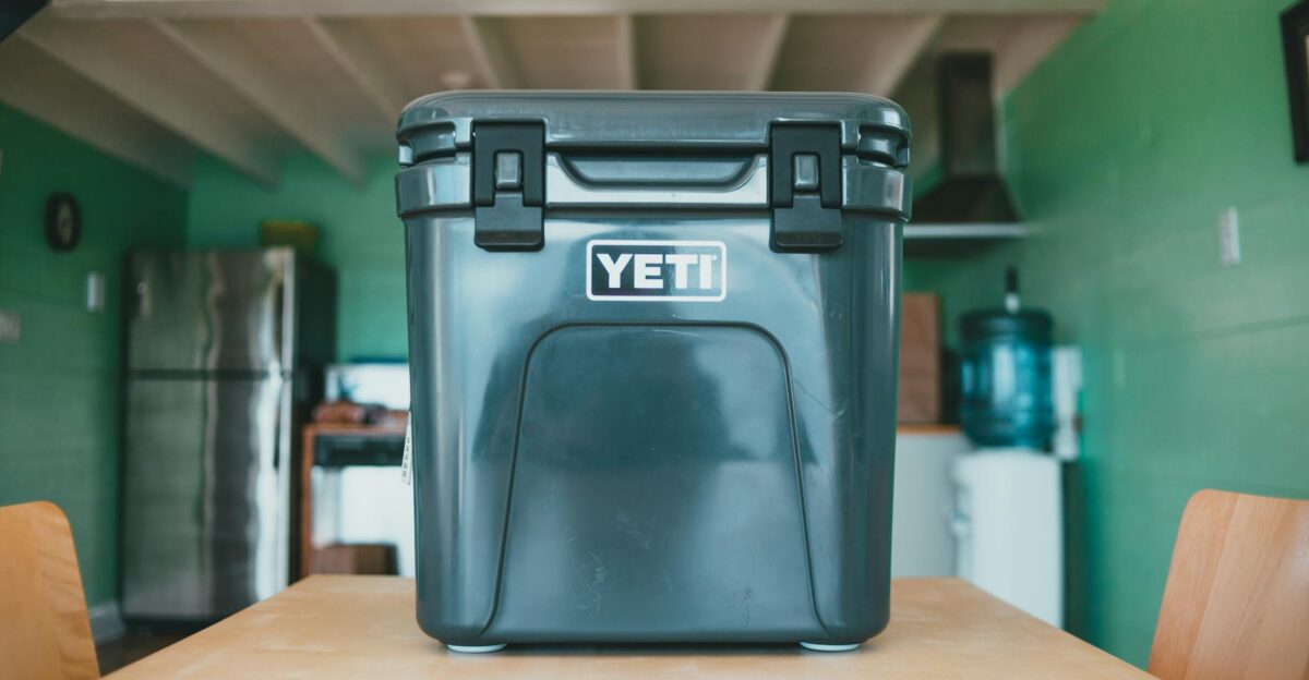 Sturdy YETI cooler placed on a wooden table in a cozy cabin-themed kitchen interior