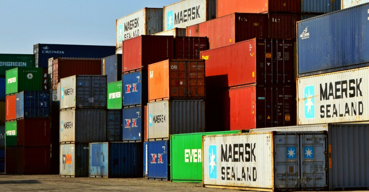 Colorful stacked shipping containers at a port exemplify global logistics.