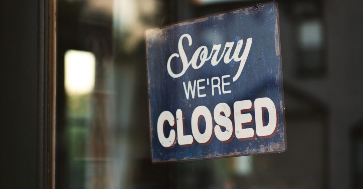 Sorry we re closed signage hanged on glass door