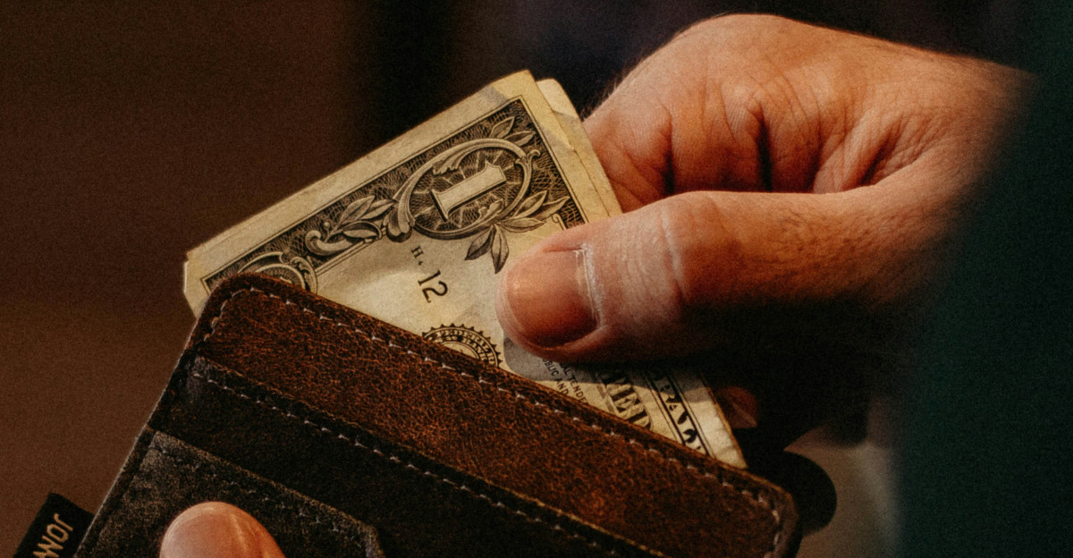 person getting 1 U S dollar banknote in wallet