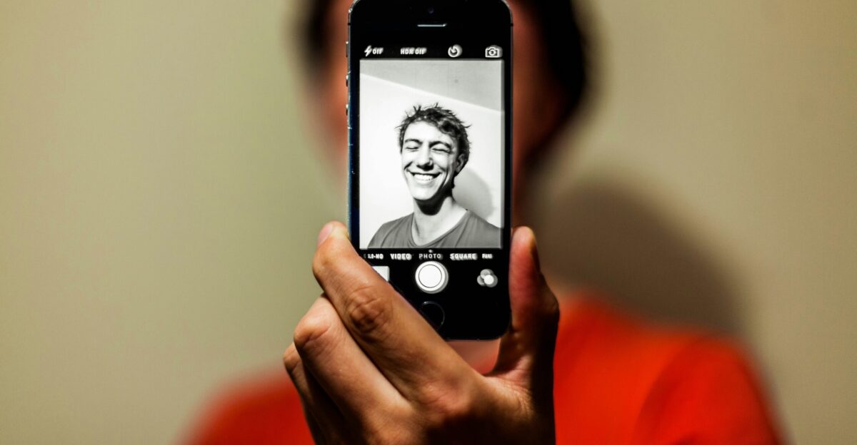 person holding space gray iPhone 5s taking picture