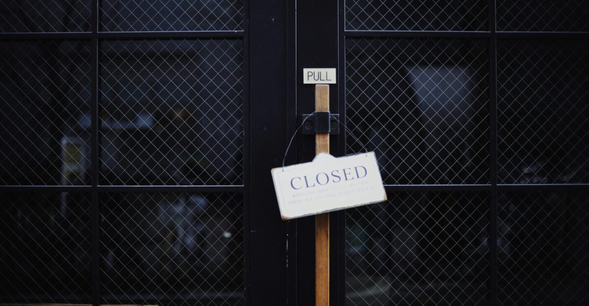 black metal gate with closed signage