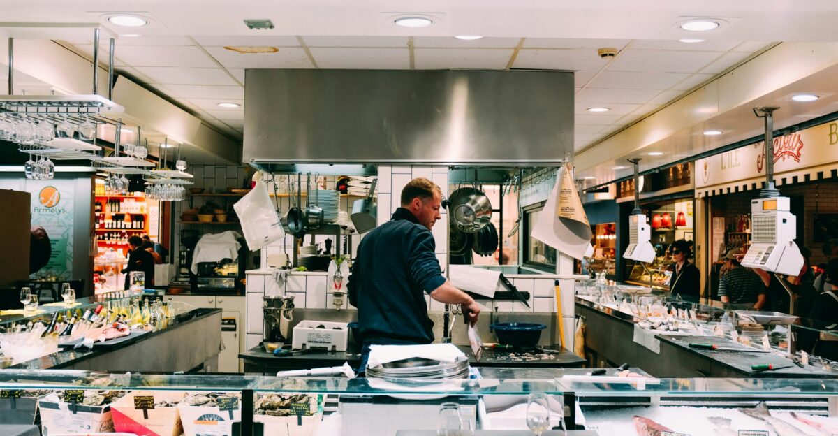 man in blue shirt behind the counter