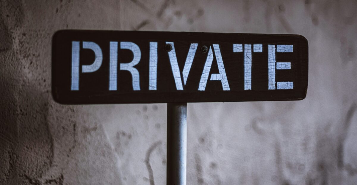 grayscale photo of black and white wooden sign