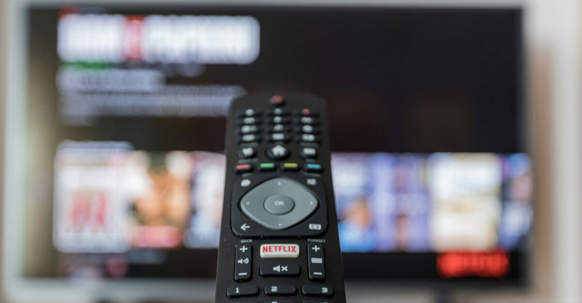 black remote control on brown wooden table