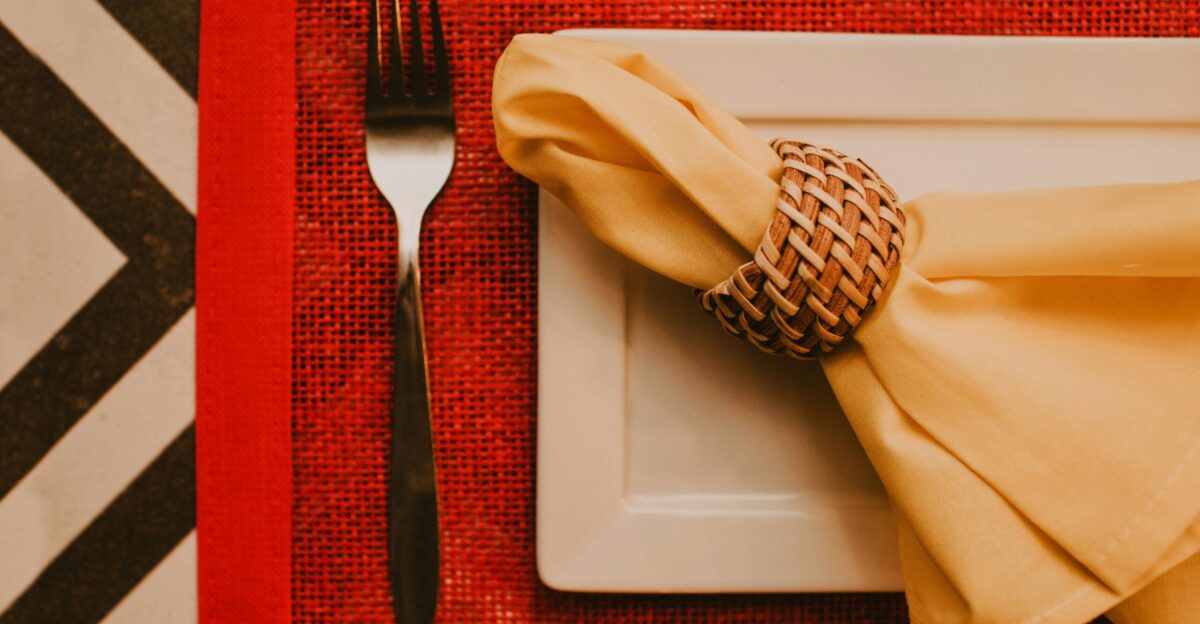 stainless steel fork and bread knife on white ceramic plate